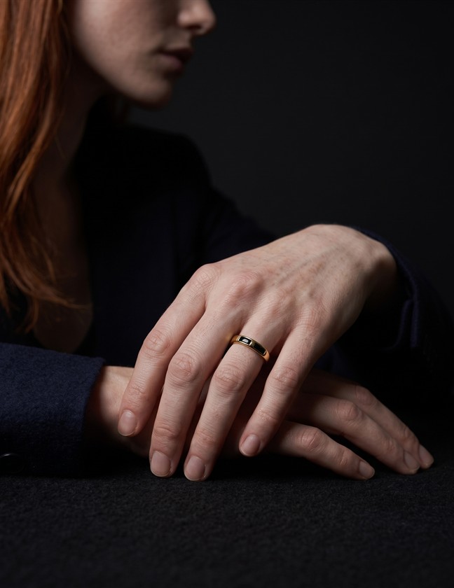 Close crop of a model wearing a band ring